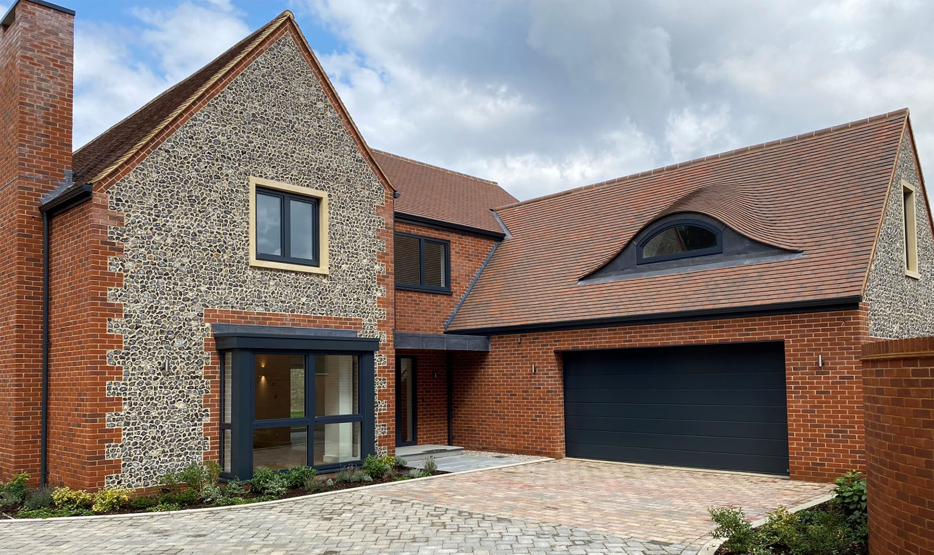 High end development by NP Architects used Dreadnought country brown sanded clay roof tiles