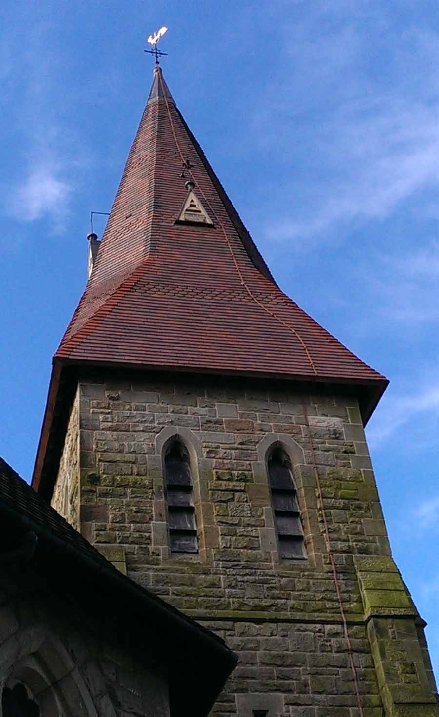 Kingstone Spire reroofed with a blend of Brown Antique Smooth Brown Brindle tiles with red purpose made hips