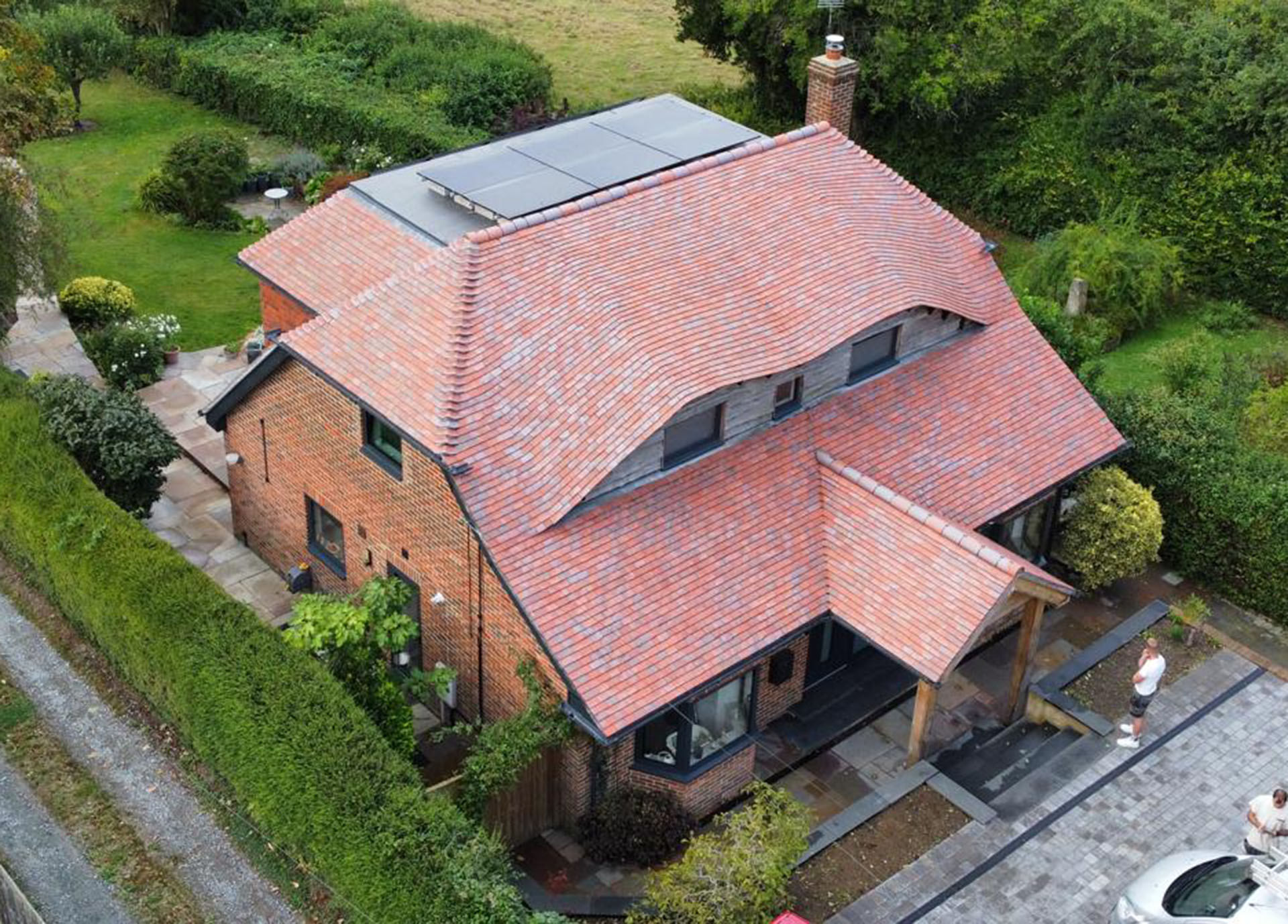 renovation with red blue blend tiles feauring double eyebrow roof by Resolute Roofing and LD Carpentry
