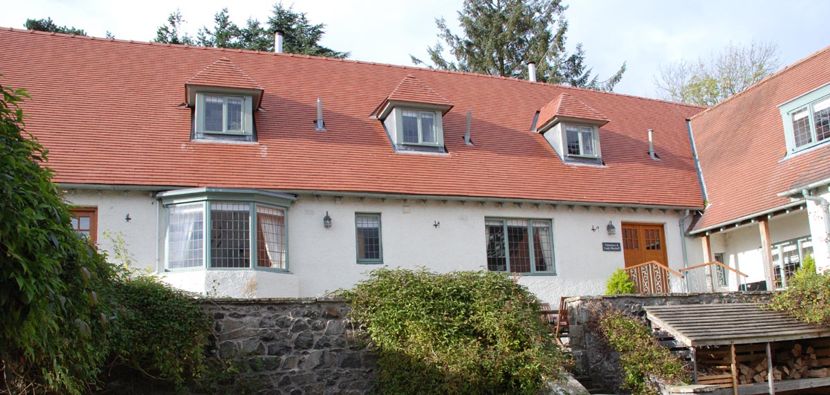 Reroofing of an Arts and Crafts house near Dundee in plum red tiles