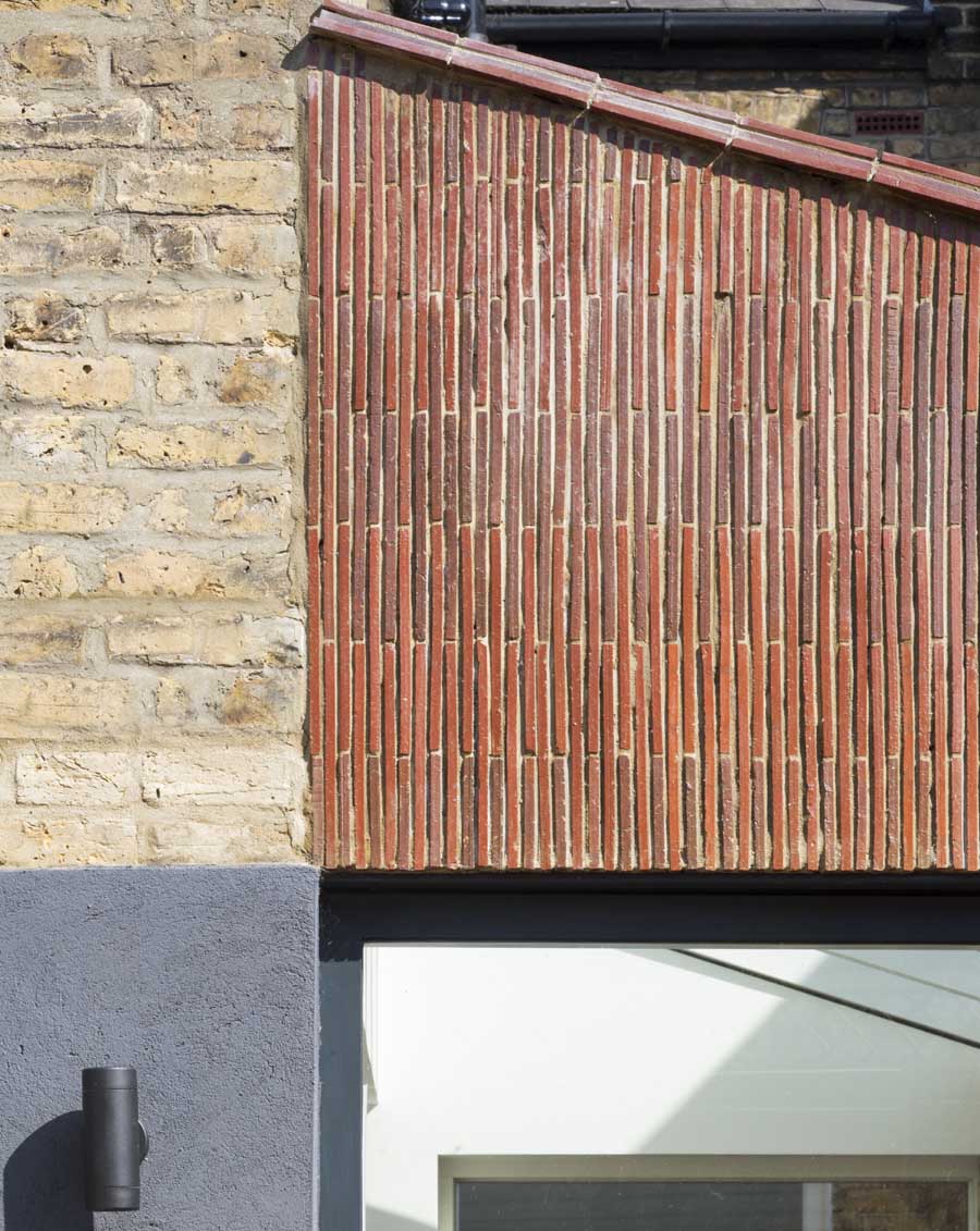 Stacked creasing tiles clad new extension