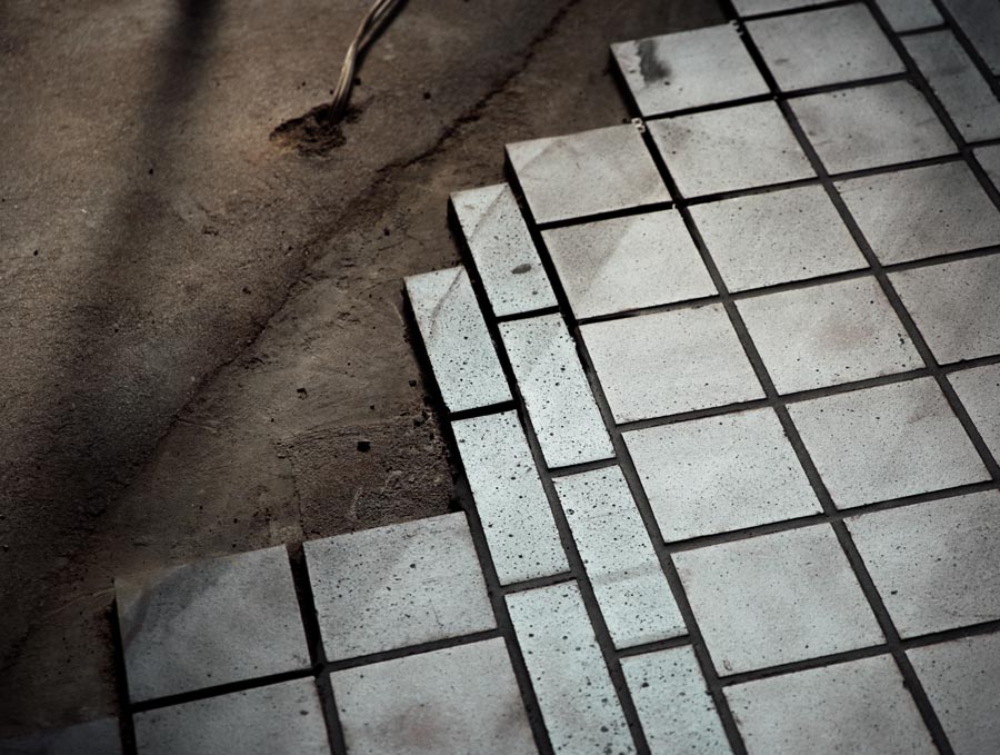 Staffs blue square quarry tiles being laid with bands of brick sized tiles