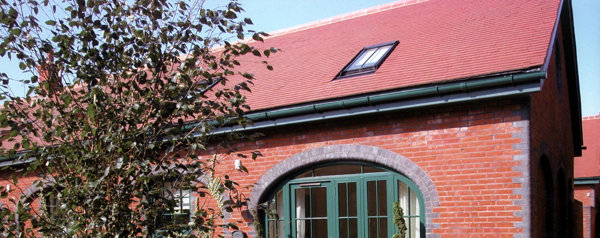 The reroofing of Clementsbury with Plum Red tiles