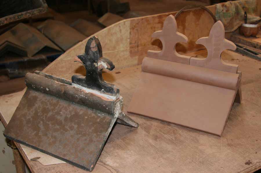 a newly made slotted roll top ridge awaiting firing together with the old ridge that it was made to match