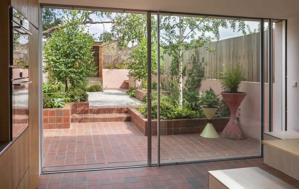 light multi square quarry tiles unite the indoor and outdoor space at a Hackney garden
