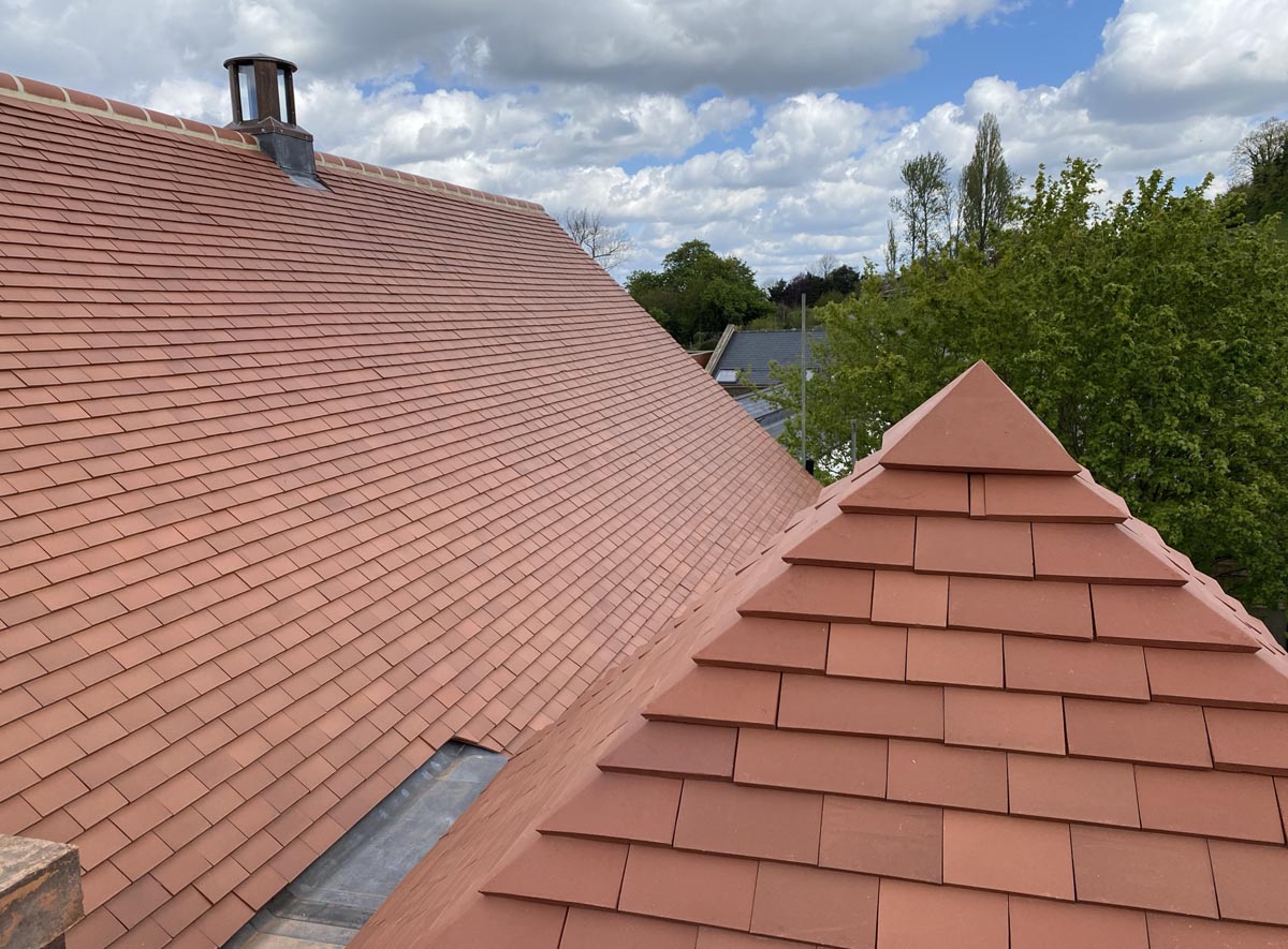 new plum red tiles on the main roof and pyramid on a listed property in Harrow