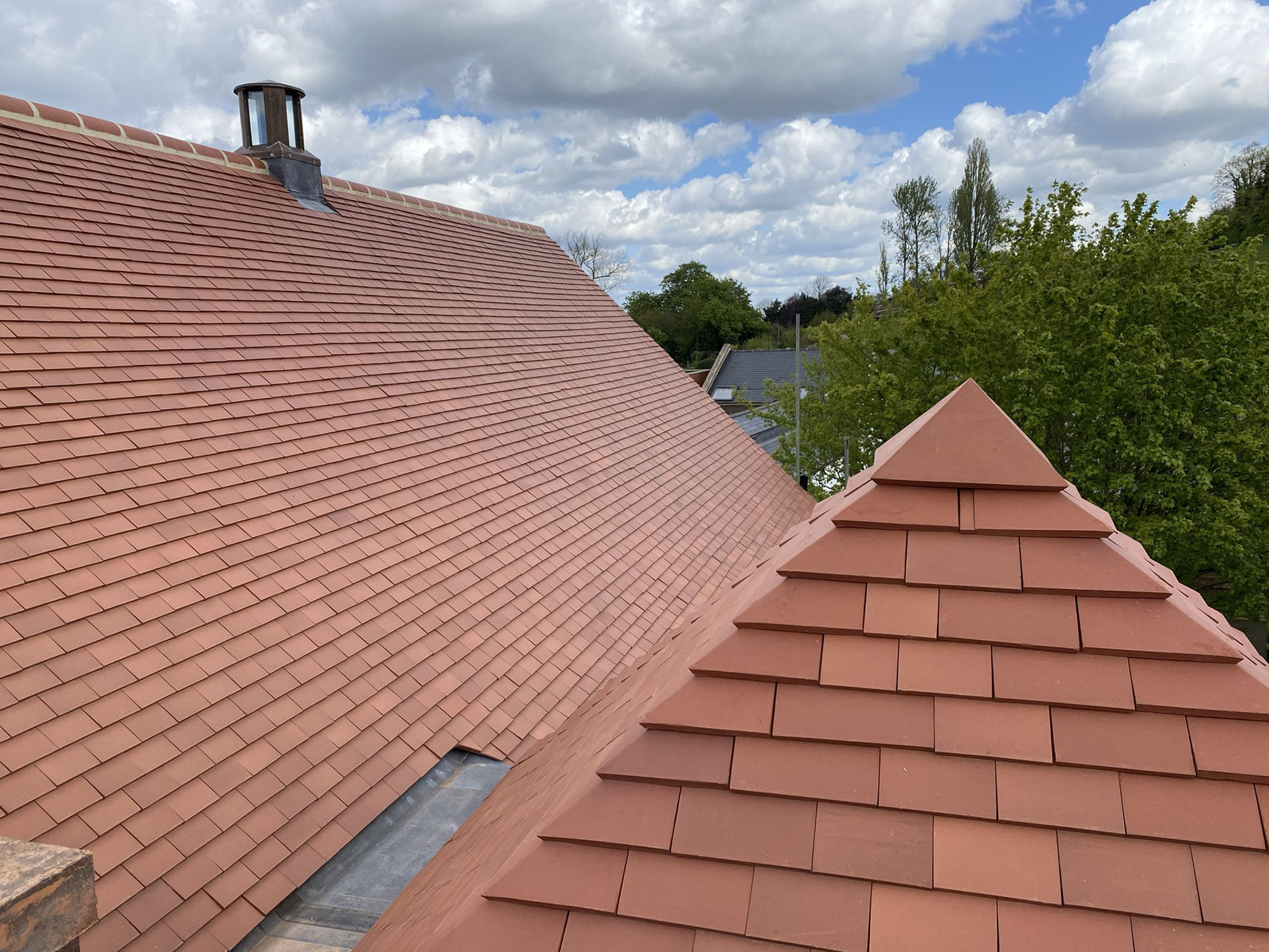 plum red tiles reroof this grade II listed property in N London